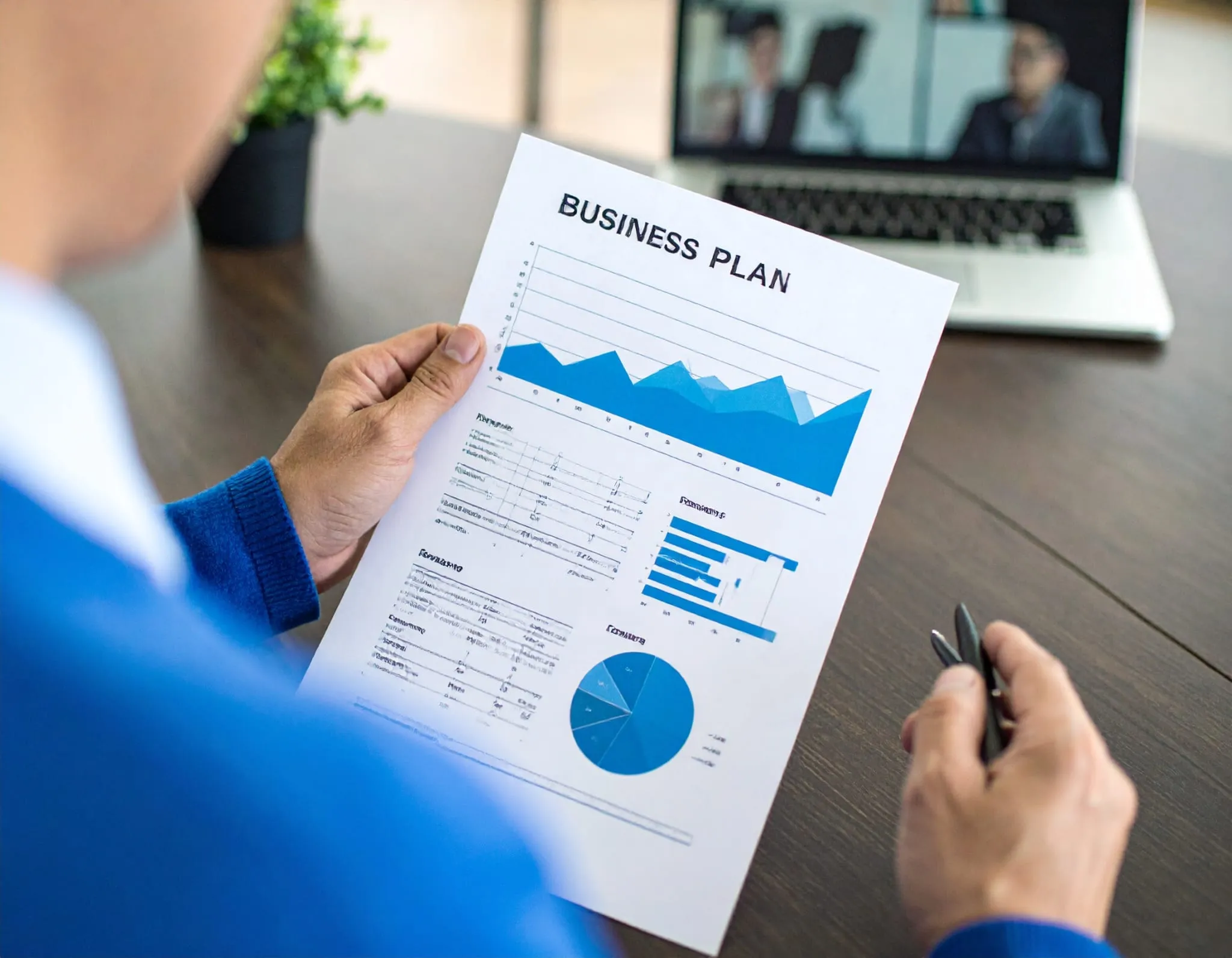 Business Planning & Forecasting Services. An accountant holding up a business plan.