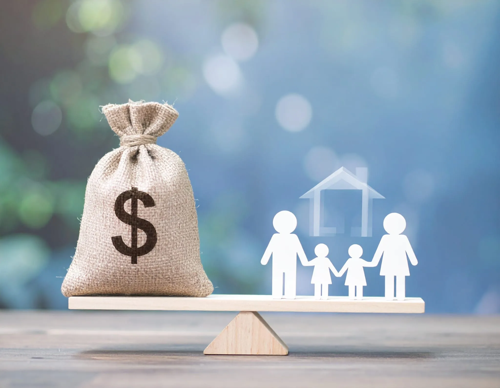 Inheritance Tax. A money bag, an abstract representation of a family on a scale depicting balance.